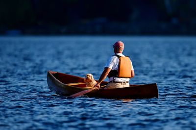 Rear view of man in boat