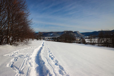 Snow covered field against sky