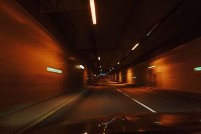 Illuminated tunnel at night