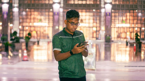 Young man standing in city