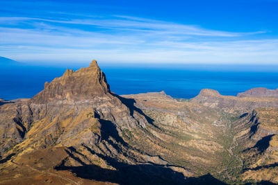 Scenic view of rock formation in sea against sky