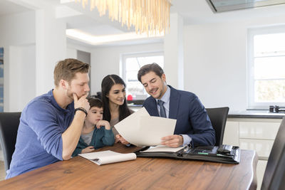 Consultant talking to family at home