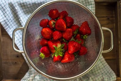 High angle view of strawberries in bowl on table