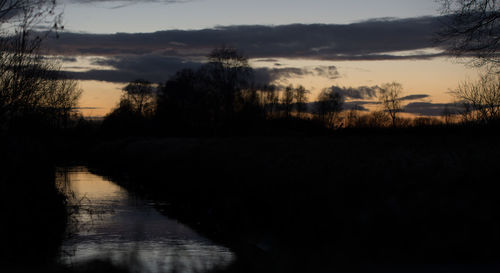 Scenic view of silhouette landscape against sky at sunset