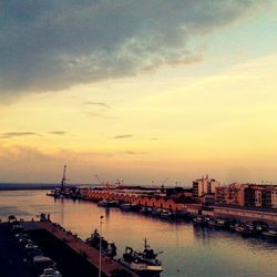 Boats in harbor at sunset