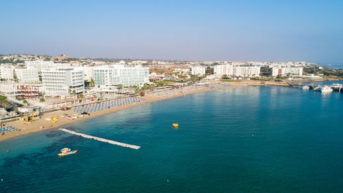 High angle view of buildings by sea against sky