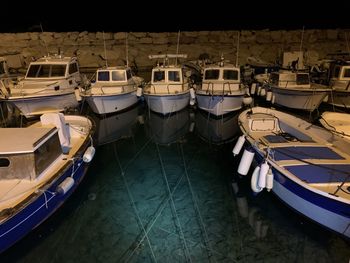 High angle view of boats moored at harbor