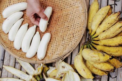 Close-up of hand holding fruit in basket