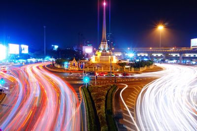 Light trails on road along buildings at night