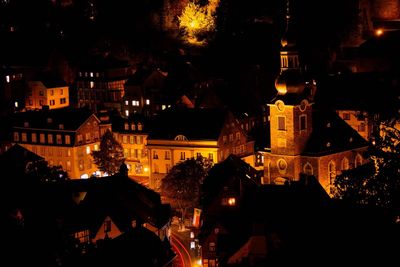 High angle view of illuminated town against sky at night