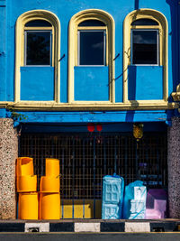 Low angle view of empty chairs against building