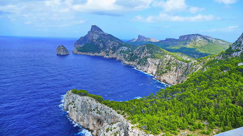 Scenic view of sea and mountains against sky