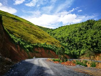 Road amidst mountains against sky