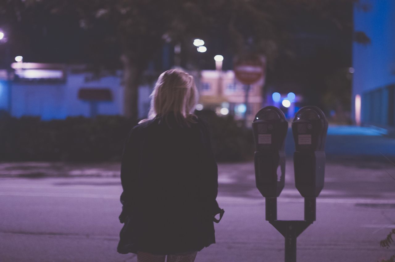 rear view, road, street, person, standing, walking, focus on foreground, night, city life, city, city street, outdoors, casual clothing