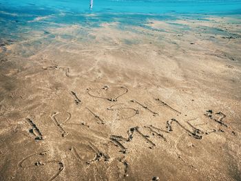 High angle view of text on beach