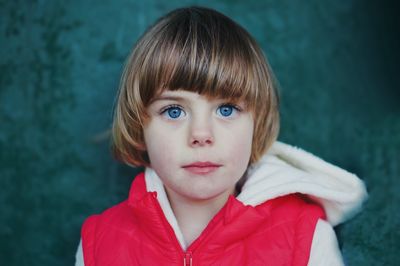 Close-up portrait of boy girl against wall