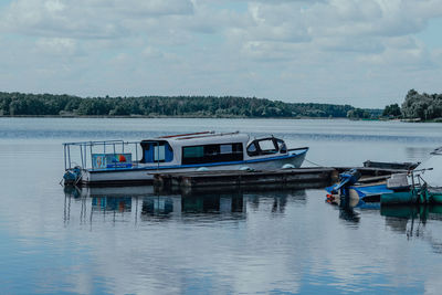 Ship moored in lake against sky