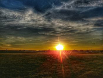 Scenic view of field against sky during sunset