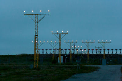 Illuminated street light against clear sky