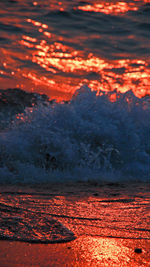 Close-up of red water against sky at sunset