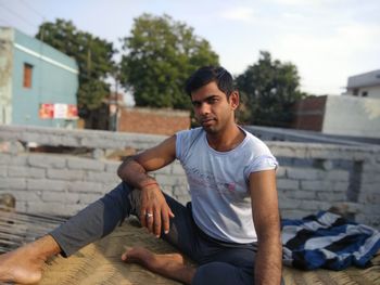 Young man sitting outdoors