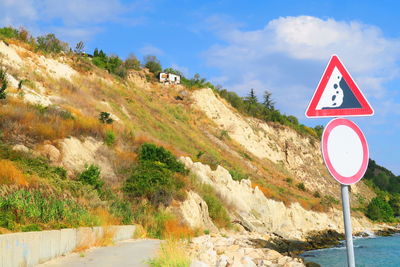 Road sign against mountain