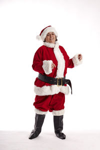 Full length portrait of man standing against red background