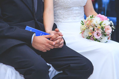 Midsection of woman holding flower bouquet