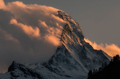 Scenic view of snowcapped mountains against sky during sunset