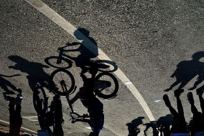 Shadow of man on street against sky