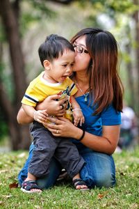 Mother embracing son at park