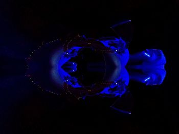 Close-up of illuminated lights over black background