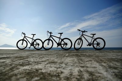 Bicycle parked against blue sky