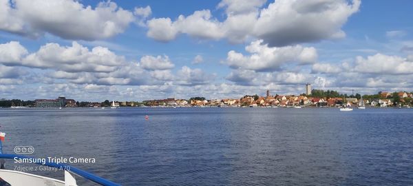 Panoramic view of sea and cityscape against sky