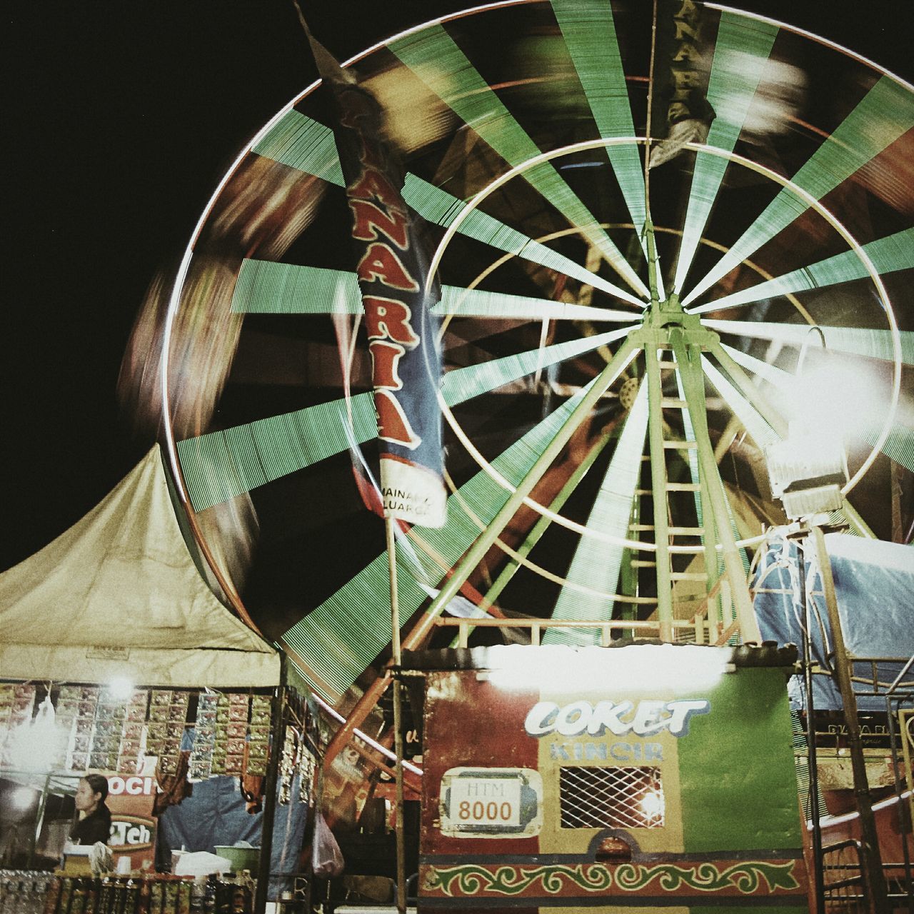 low angle view, arts culture and entertainment, built structure, architecture, amusement park, amusement park ride, building exterior, ferris wheel, night, illuminated, outdoors, travel destinations, travel, incidental people, no people, technology, modern, tourism, famous place