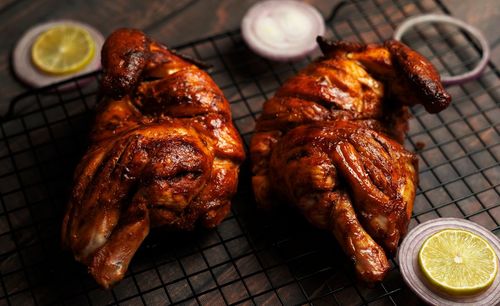High angle view of meat on barbecue grill