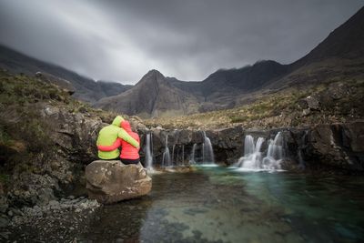 Scenic view of waterfall against sky