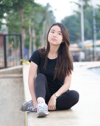 Young woman sitting outdoors