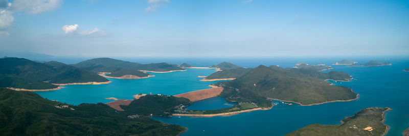 Scenic view of sea and mountains against sky