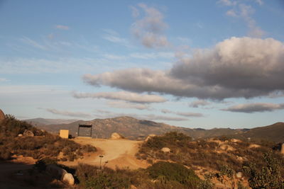 Scenic view of mountains against cloudy sky