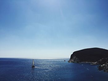 High angle view of boat moving on sea against clear blue sky