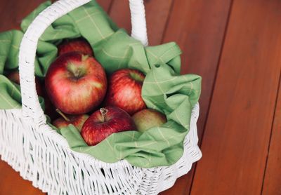 High angle view of apples in basket on table