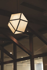 Low angle view of illuminated pendant lights hanging from ceiling