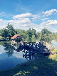 Scenic view of lake by building against sky