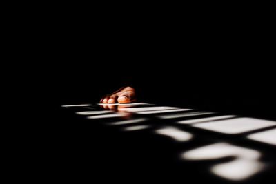 Close-up of human hand against black background