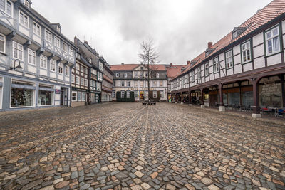 Street amidst buildings in town against sky