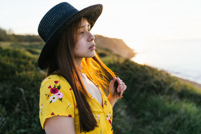 Young woman looking away outdoors