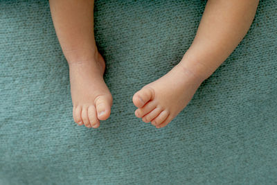 Low section of baby feet