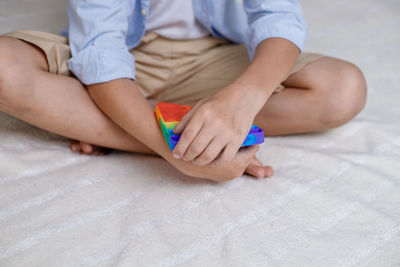 High angle view of baby girl playing on bed