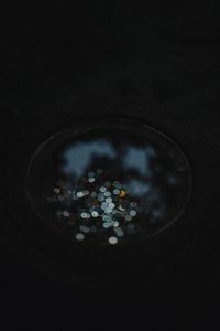 High angle view of coins in pond